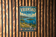 A vintage metal sign displaying the name "Vranksko Lake" and the word "Croatia" is mounted on a wooden wall.