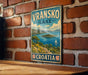A vintage-style metal sign displaying the name "Vranksko Lake" and the word "Croatia" is hanging on a brick wall.