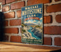 A vintage-style metal sign for Waikiki Whitestone Park in New Zealand, featuring a scenic landscape with a river and mountains.