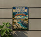 A vintage-style metal sign for Waitaki Whitestone Park in New Zealand, featuring a scenic landscape with mountains, a river, and lush vegetation.