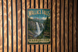 A vintage metal sign for Wallace Falls State Park in Washington, featuring a waterfall and forest landscape.