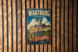A vintage metal sign for Wartburg Castle, featuring a castle illustration and the text "Wartburg Castle Germany" in a decorative font.