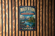 A vintage-style metal sign for Waterton Lakes Biosphere Reserve in Canada, featuring a scenic landscape with mountains, a lake, and a deer.