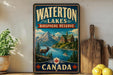 A vintage-style sign for Waterton Lakes Biosphere Reserve in Canada, featuring a scenic landscape with mountains, a lake, and a lodge.