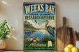 A vintage-style sign for Weeks Bay National Estuarine Research Reserve in Alabama, featuring a blue background with a bird illustration and text promoting the reserve.
