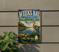A vintage-style sign for Weeks Bay National Estuarine Research Reserve in Alabama, featuring a bird, a river, and a coastal landscape.