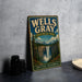 A vintage-style metal sign for Wells Gray Provincial Park in British Columbia, featuring a scenic image of a waterfall surrounded by pine trees.