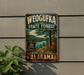 A vintage-style metal sign for Weoguffee State Forest in Alabama, featuring a scenic landscape with a lake and pine trees.