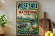 A vintage-style poster advertising West Lake, a cultural landscape in Hangzhou, China, featuring a scenic image of a traditional Chinese boat on the lake.