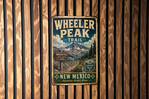 A vintage metal sign for Wheeler Peak Trail in New Mexico, featuring a mountain landscape and trail information.