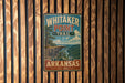 A vintage metal sign for Whitaker Point Trail in Arkansas, featuring a scenic mountain landscape.