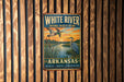 A vintage metal sign for the White River National Wildlife Refuge in Arkansas, featuring an illustration of ducks and a sunset over a river.