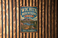 A vintage metal sign with the text "WICHITA MOUNTAINS TRAIL" and "OKLAHOMA" is displayed on a wooden wall.