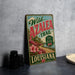 A vintage-style sign for the Wild Azalea Trail in Louisiana, featuring a scenic landscape with a road and flowers.