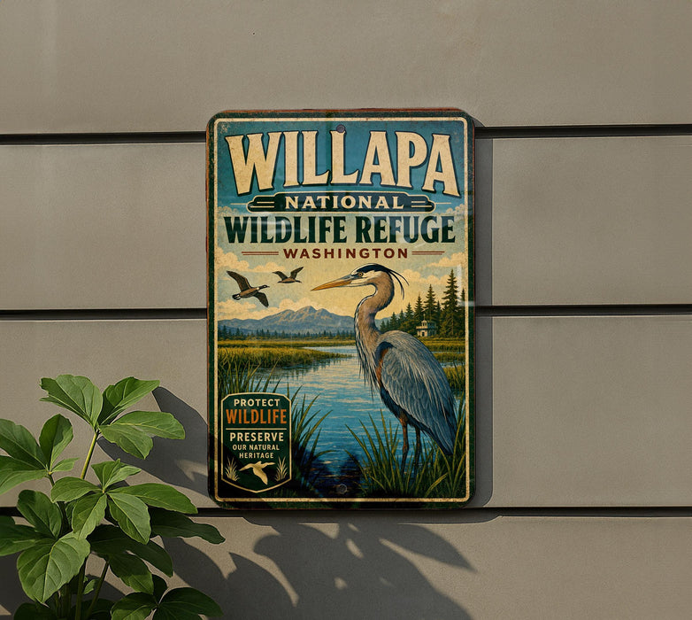 A vintage-style metal sign for the Willapa National Wildlife Refuge in Washington, featuring an illustration of a crane and a lake surrounded by trees.