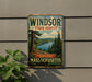 A vintage metal sign for the Windsor State Forest in Massachusetts, featuring a scenic landscape with pine trees, a lake, and mountains.
