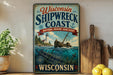 A vintage-style metal sign for the Wisconsin Shipwreck Coast National Marine Sanctuary, featuring a lighthouse, shipwreck, and ocean scene.