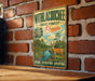 A vintage metal sign with a deer and palm trees, mounted on a brick wall.