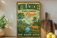 A vintage-style metal sign with a painting of a deer in a forest, surrounded by palm trees and a river, advertising the Withlacoochee State Forest in Florida.
