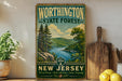 A vintage-style sign for WorthINGTON STATE FOREST, New Jersey, featuring a scenic landscape with pine trees, a lake, and mountains.