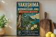 A vintage-style sign for the Yakushima and Kuchinoerabu Jima Bioserve Reserve in Japan, featuring a tropical landscape with a mountain, river, and flowers.