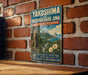 A vintage-style sign for the Yakushima and Kuchinoerabu Jima Biosphere Reserve in Japan, featuring a lush tropical landscape with mountains, waterfalls, and flowers.