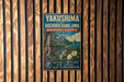 A vintage-style metal sign with text and an illustration of a mountainous landscape, mounted on a wooden wall.