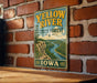 A vintage-style metal sign for the Yellow River State Forest in Iowa, featuring a scenic illustration of the river and surrounding landscape.