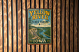 A vintage-style metal sign for the Yellow River State Forest in Iowa, featuring a scenic illustration of the river and surrounding landscape.