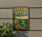 A vintage-style metal sign for the Yellow River State Forest in Iowa, featuring a scenic illustration of a river and mountains.
