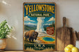 A vintage-style sign for Yellowstone National Park, featuring a bison and a geyser, is displayed on a wooden shelf next to a wooden cutting board and some lemons.