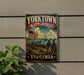 A vintage-style metal sign with the text "YORKTOWN BATTLEFIELD VIRGINIA" and an illustration of a cannon, two soldiers, and an American flag.