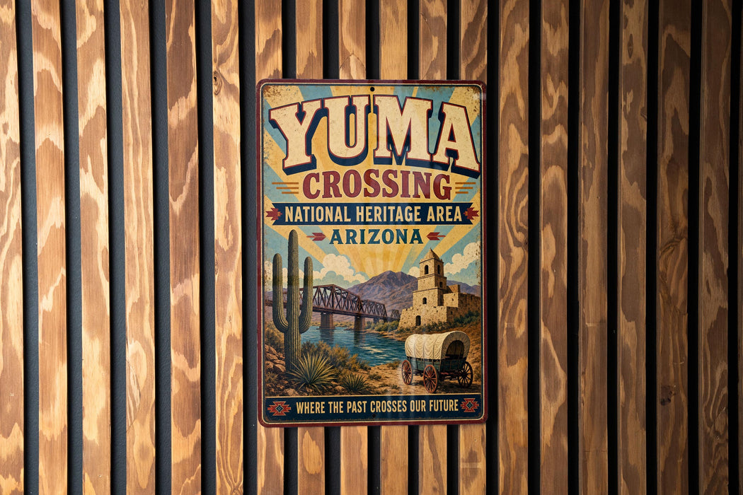 A vintage-style metal sign for Yuma Crossing, a National Heritage Area in Arizona, featuring a desert landscape with a bridge and a wagon.