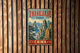 A vintage metal sign with the text "Zhangjiajie Park" and "CHINA" is displayed on a wooden wall.