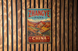 A vintage metal sign with the text "Zhangye Park - China" is displayed on a wooden wall.