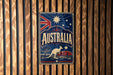 A vintage-style metal sign with the word "AUSTRALIA" prominently displayed, featuring a kangaroo and the Australian flag.