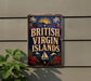 A vintage-style sign that reads "British Virgin Islands" is displayed on a wall, with a plant to the left of the sign.