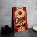 A vintage-style metal sign with the word "Canada" prominently displayed, featuring a red maple leaf and a mountain landscape.