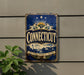 A vintage metal sign with the word "Connecticut" displayed prominently, featuring a lighthouse and other scenic elements.