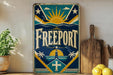 a vintage-style sign with the word "FREEPORT" prominently displayed, surrounded by various decorative elements such as a sun, palm trees, and a lighthouse.