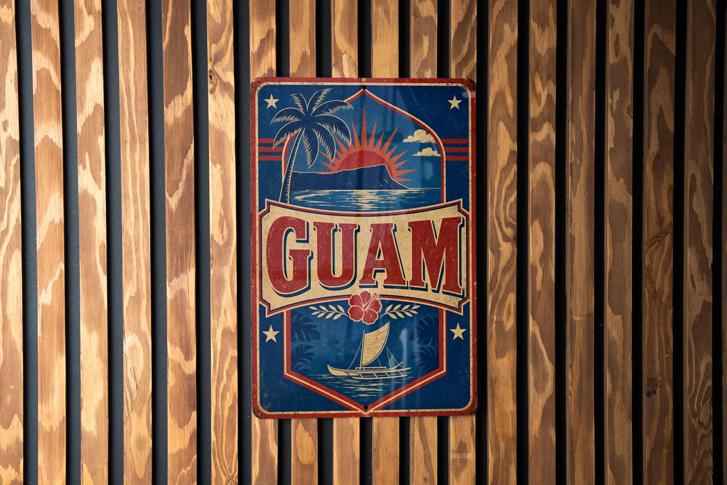 A vintage-style metal sign with the word "GUAM" prominently displayed, featuring a palm tree, sun, and other tropical elements.