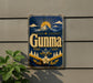 a vintage-style sign with a mountain landscape and sun design, mounted on a wall.