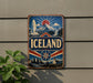 a vintage-style sign with the word "ICELAND" prominently displayed, along with a mountain and waterfall scene.