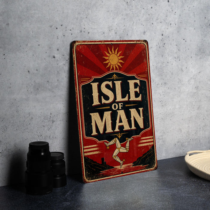 A vintage-style sign with the text "ISLE OF MAN" is displayed on a table, accompanied by a stack of black camera lenses and a white dish.