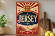 A vintage Jersey sign with a red and white design, featuring a crown and sunburst pattern, is displayed on a shelf next to a wooden cutting board and some lemons.