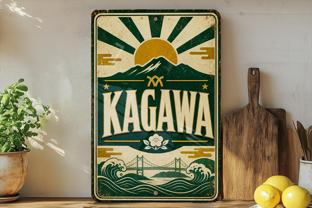 A vintage-style metal sign with the word "KAGAWA" prominently displayed, featuring a sun and mountain design. The sign is placed on a shelf next to a wooden cutting board and a potted plant.