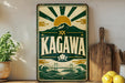A vintage-style metal sign with the word "KAGAWA" prominently displayed, featuring a sun and mountain design. The sign is placed on a shelf next to a wooden cutting board and a potted plant.