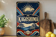 A vintage-style sign for "Kagoshima" is displayed on a shelf, featuring a mountain, sun, and traditional Japanese architecture.