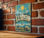 A vintage-style metal sign with the word "Kazakhstan" prominently displayed, featuring a sun and mountains in the background.