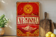 a vintage-style sign with the word "KYRGYZSTAN" prominently displayed, along with a sun and mountain motif. The sign is placed on a shelf next to a wooden cutting board and a potted plant, creating a rustic and homey atmosphere.